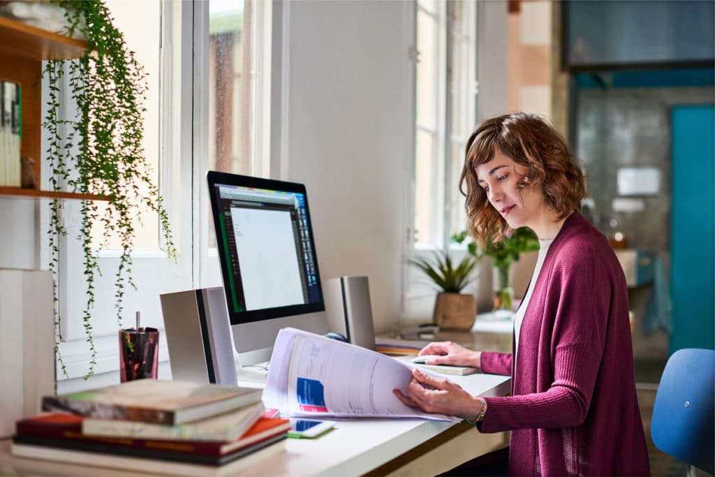 A woman doing her remote work from her home office.